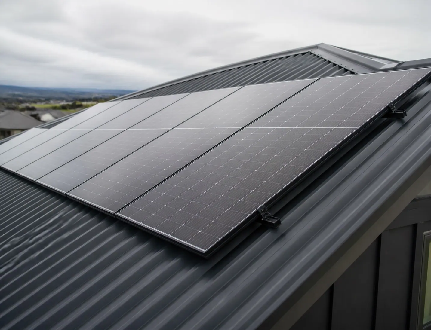 Solar panels mounted on a dark long-run metal roof in Canterbury