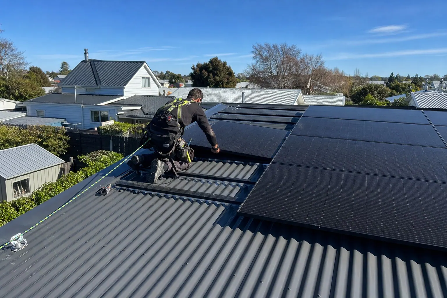 Solar panels being installed on a Canterbury long-run metal roof